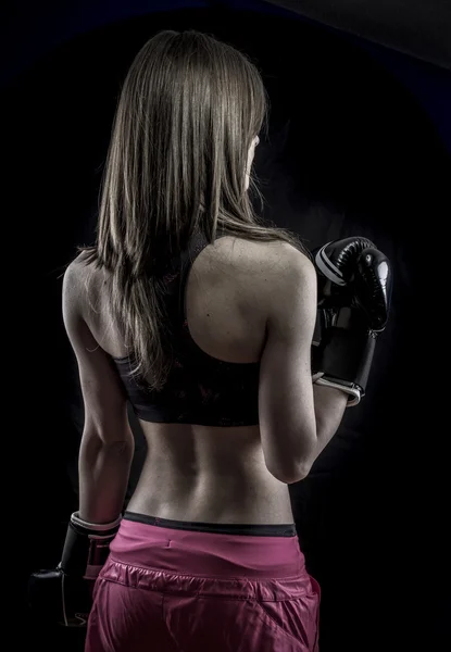 Champion, strong woman athlete with boxing gloves