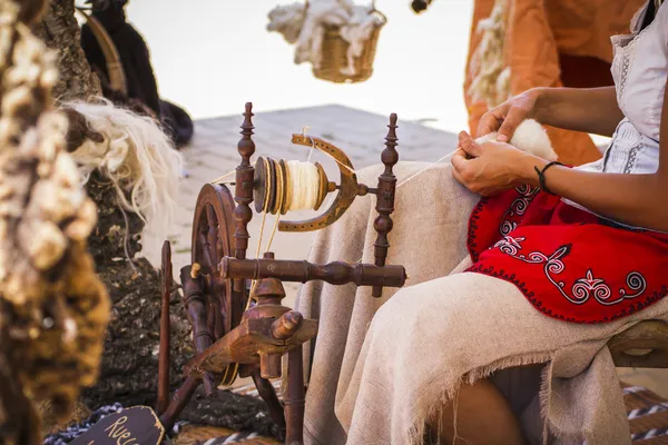 Woman spinning yarn