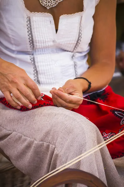 Woman spinning yarn