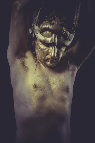 Man with body painted gold