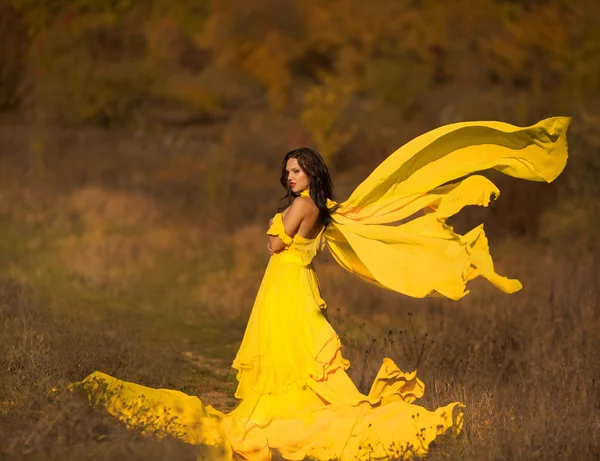 Beautiful girl in a yellow dress air