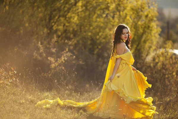 Beautiful girl in a yellow dress air