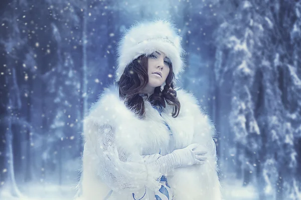 Beautiful snow queen in winter forest