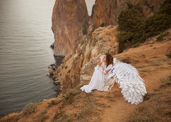 Woman with wings on mountain