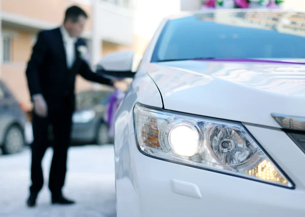 Man in a suit sits in a luxury car