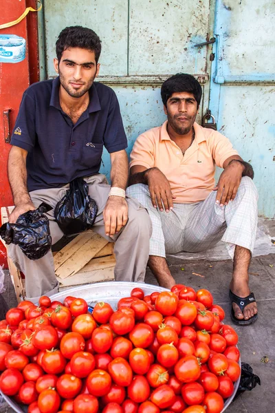 Men sell tomatoes