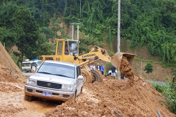 Bulldozer clears the road because of landslide