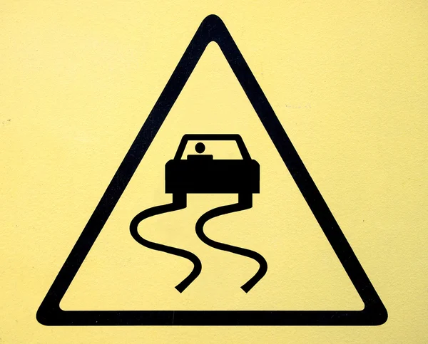 Slippery when wet road sign