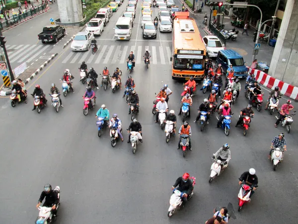 BANGKOK - NOV 17: Motorcyclists and cars wait at a junction during rush hour on Nov 17, 2012 in Bangkok, Thailand. Motorcycles are often the transport of choice for Bangkok's heavily congested roads.