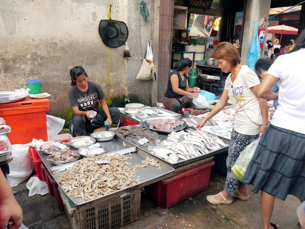 BANGKOK, THAILAND - SEPTEMBER 8: Unidentified woman selling fish on the local market in Bangkok, Thailand on September 8, 2012.
