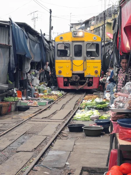 MAEKLONG, THAILAND - SEPTEMBER 7: The famous railway markets at Maeklong, Thailand, September 7, 2013, Samut Songkhram, Thailand.Three times a day the train runs through these stalls.