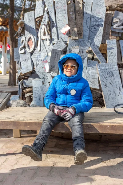 Boy waiting at the meeting point in front of Nami Island.