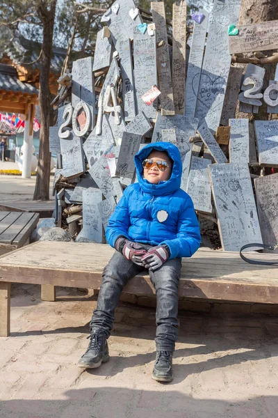 Boy waiting at the meeting point in front of Nami Island.