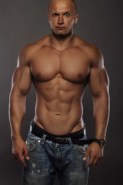 Muscular male bodybuilder on black background