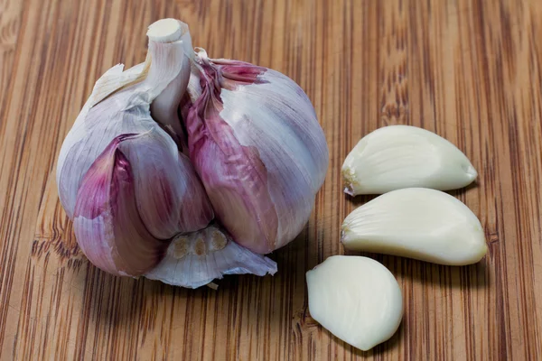 Single garlic with cloves on the board