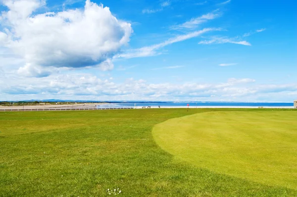 Golf green St Andrews old course, West Sands beach. Scotland.