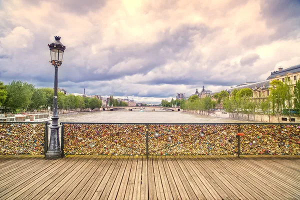 Love padlocks on Pont des Arts bridge, Seine river in Paris, France.