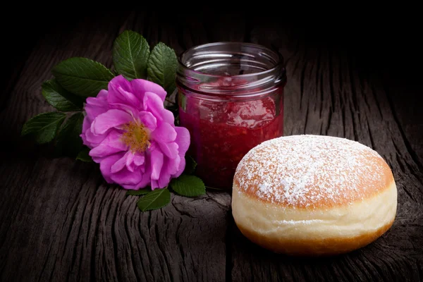 Fresh baked donut and red fruit jam