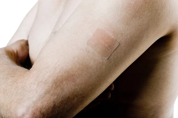 Man arm with nicotine patch