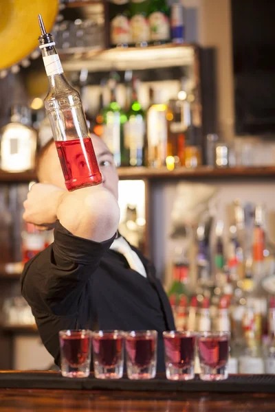 Professional barmen making cocktail