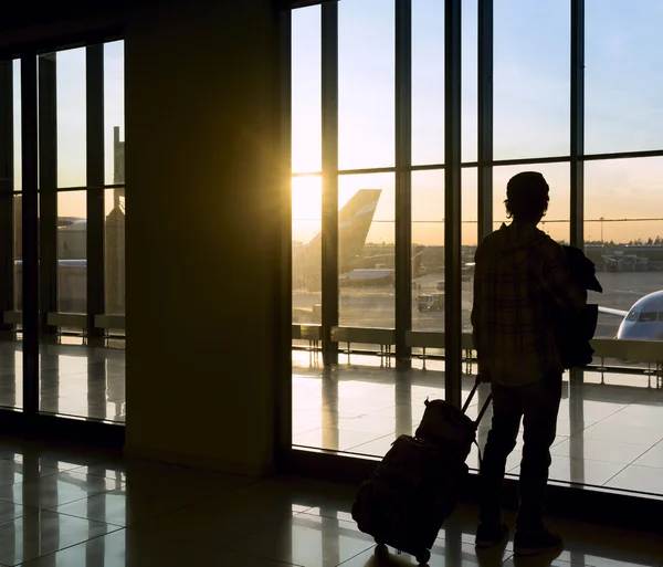 Silhouette of man near window in airport