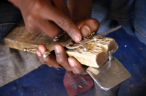 Close up of artisan with meatalwork in Niger