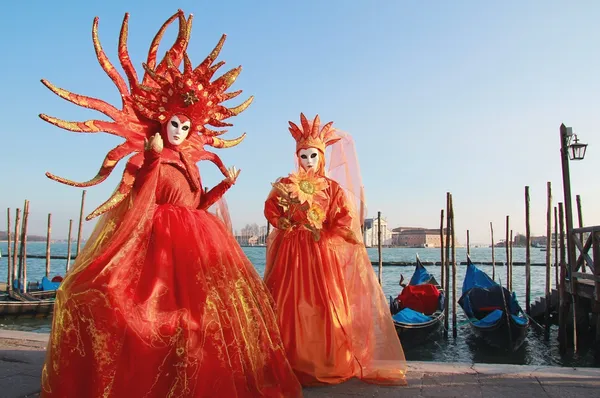 Orange veils masked couple at Venice Carnival