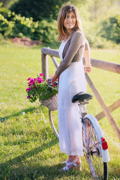 Beautiful  woman with a vintage bike