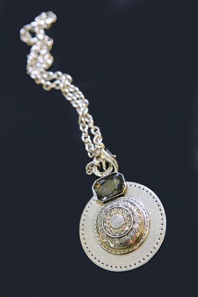 Silver medallion with stone on chain