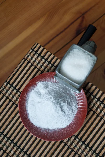 Grinding of sugar to the powder.