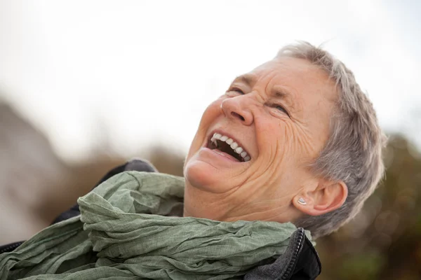 Happy grey-haired elderly woman senior outdoor