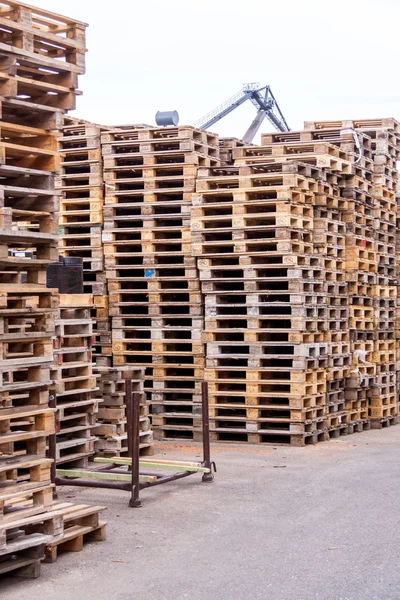 Stacks of old wooden pallets in a yard