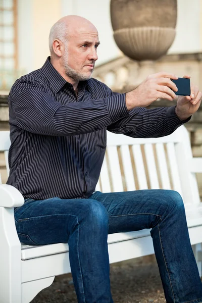 Man taking a photograph with mobile