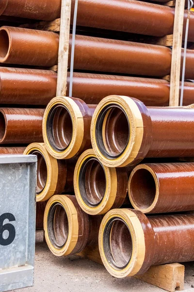 Several pipes stacked in yard