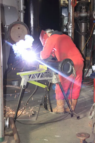 A welder wearing his full personal protection equipment, ppe