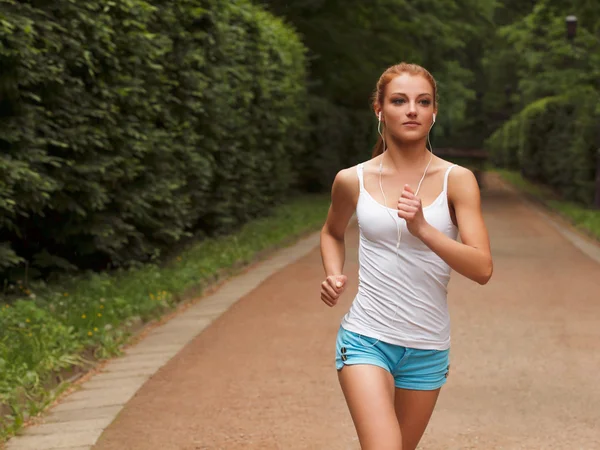 Running woman. Female runner jogging during outdoor