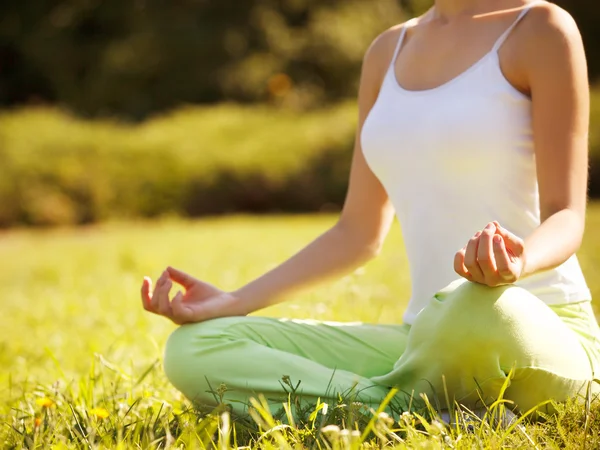 Portrait of young woman meditating in pose of lotus. Yoga backgr