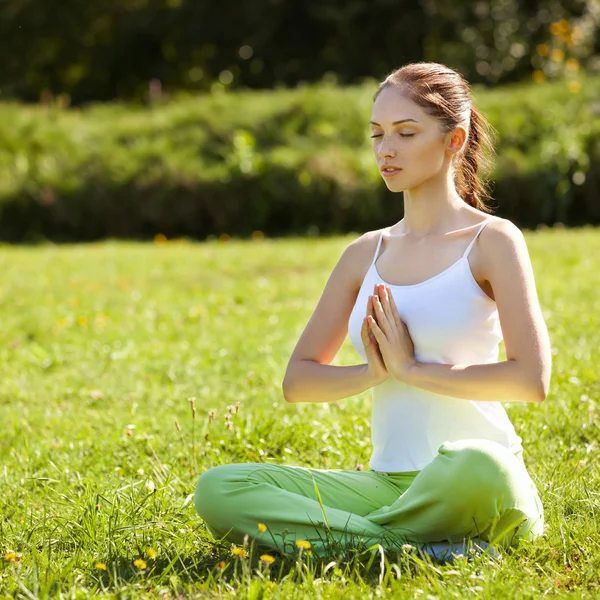 Young and beautiful woman doing yoga exercises .Yoga background