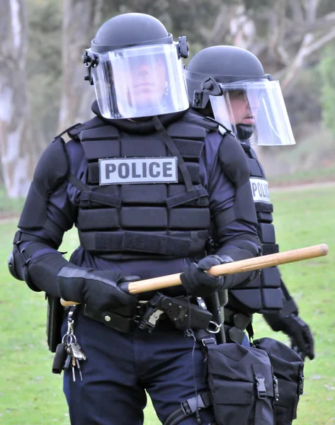 Show of force - police in riot gear move toward the civil unrest