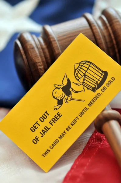 Yellow playing card with gavel atop US flag