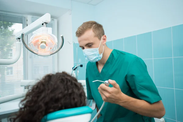 Dentist in mask at his dental office