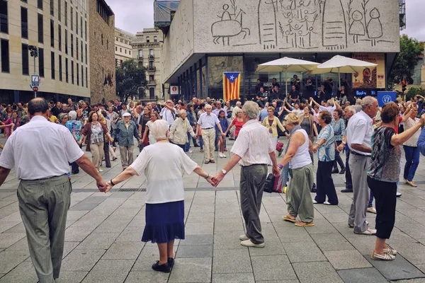 People dancing national dance Sardana in Barcelona, Spain