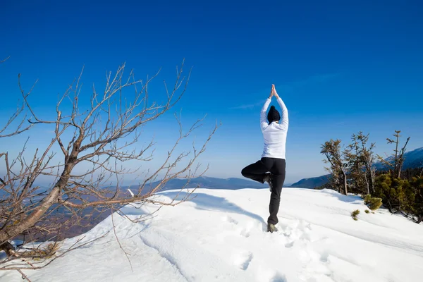 Winter yoga session in beautiful mountain place