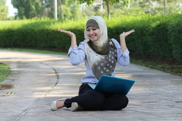 Beautiful young Muslim girl happy emotion with laptop