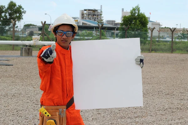 Angry oil and gas asian worker with blank sign, ready for your t