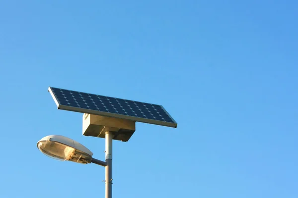 Solar powered city lamp isolated on blue sky with copyspace