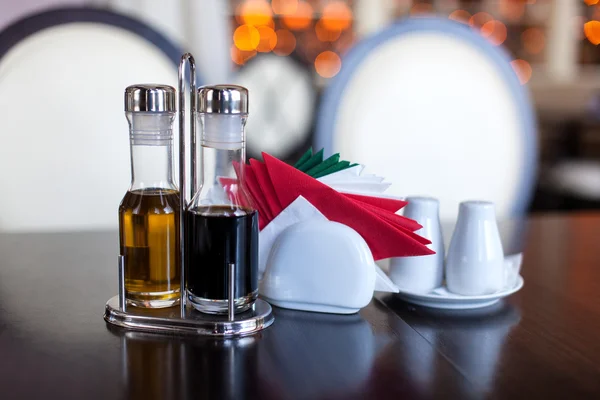 Napkins, olive oil and vinegar are on table