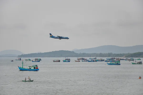 Plane Flying above Fishing Boats