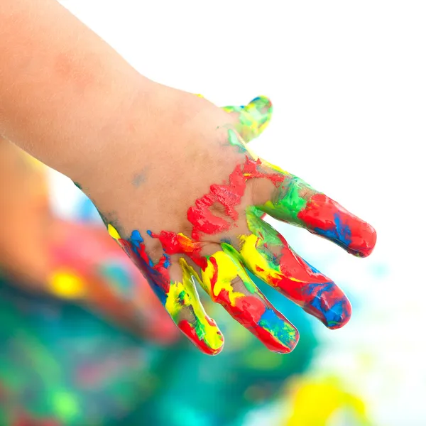 Colorful painted infant hand.