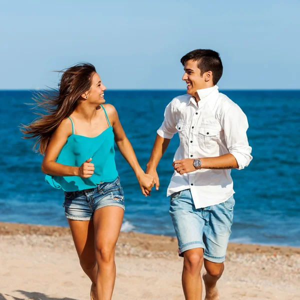 Handsome teen couple running